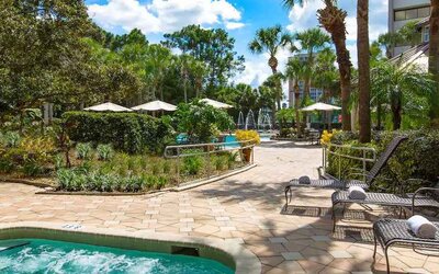 Beautiful outdoor patio with plants by the pool at the DoubleTree Suites by Hilton Orlando - Disney Springs Area.
