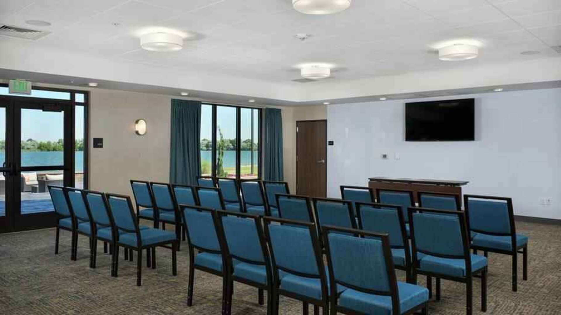 Meeting room with tables and screen at the Hampton Inn Burley.