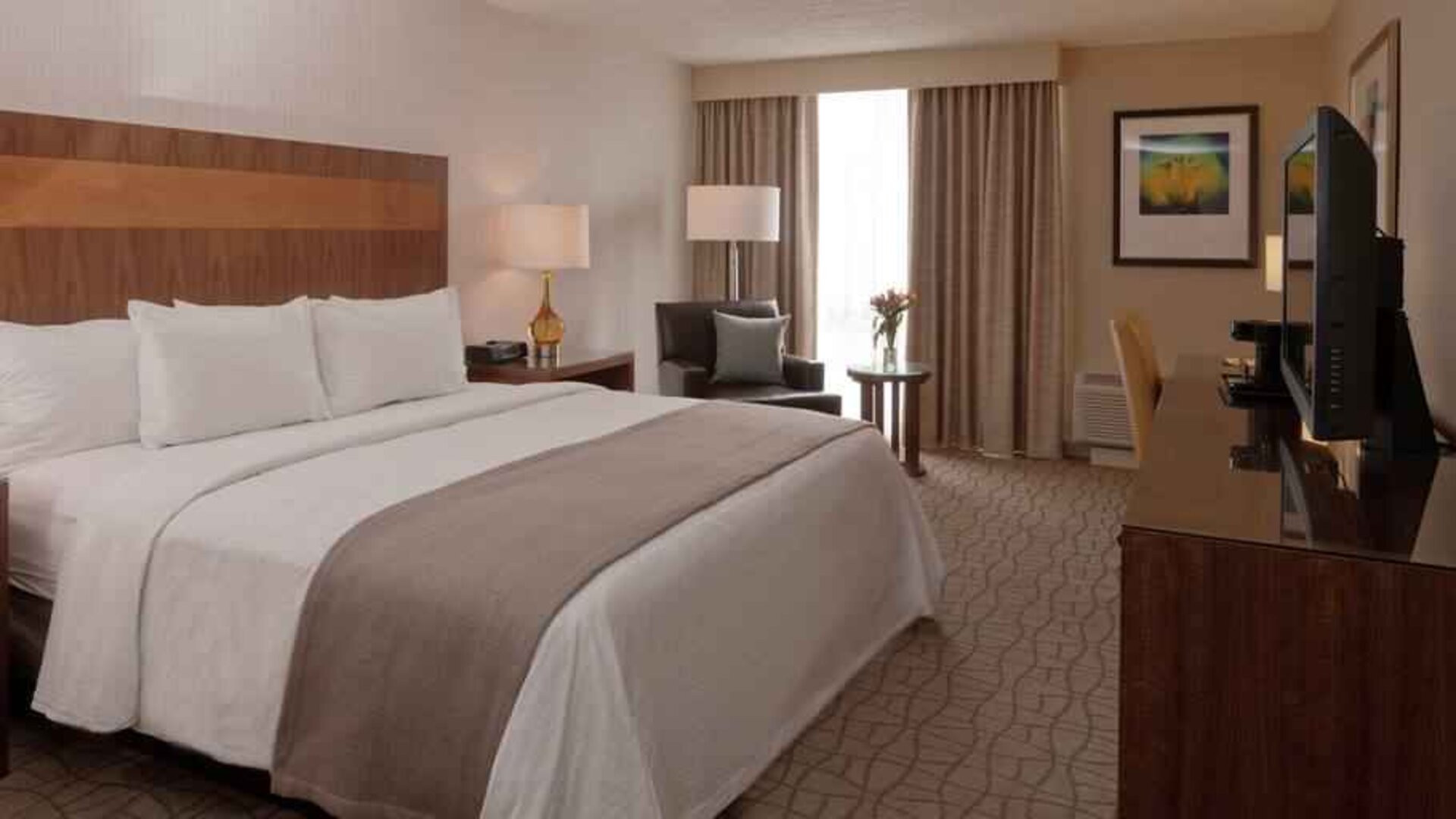 King guestroom with desk and TV screen at the DoubleTree by Hilton Pittsburgh Green Tree.