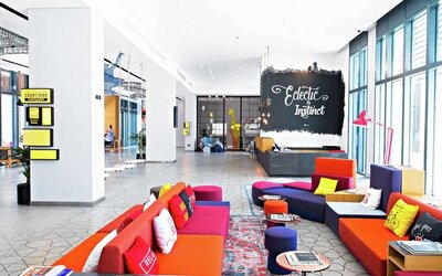 Colorful chairs and couches fill this eclectic stimulating hotel lounge area at Hilton Dubai Al Seef.