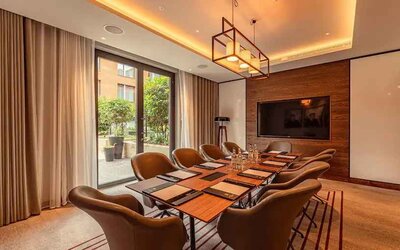 Small meeting room with TV screen at the Fellows House Cambridge, Curio Collection by Hilton.