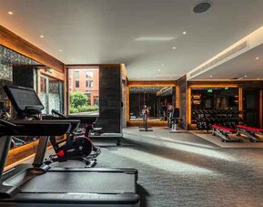 Fully equipped fitness center at the Fellows House Cambridge, Curio Collection by Hilton.