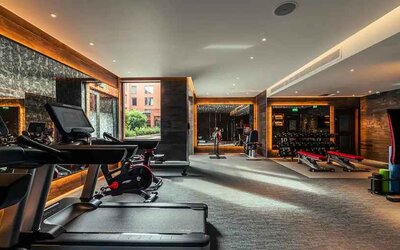 Fully equipped fitness center at the Fellows House Cambridge, Curio Collection by Hilton.