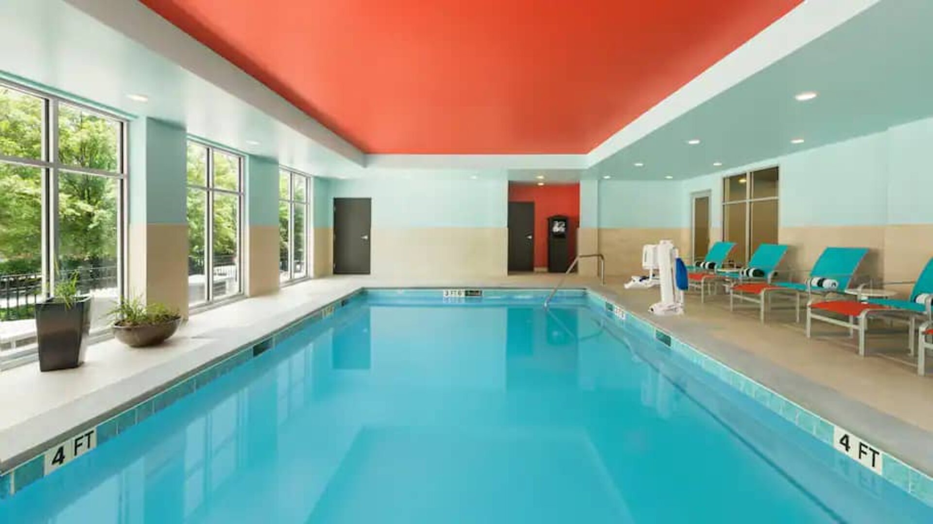 Indoor pool with pool chairs at the Homewood Suite by Hilton Atlanta Perimeter.