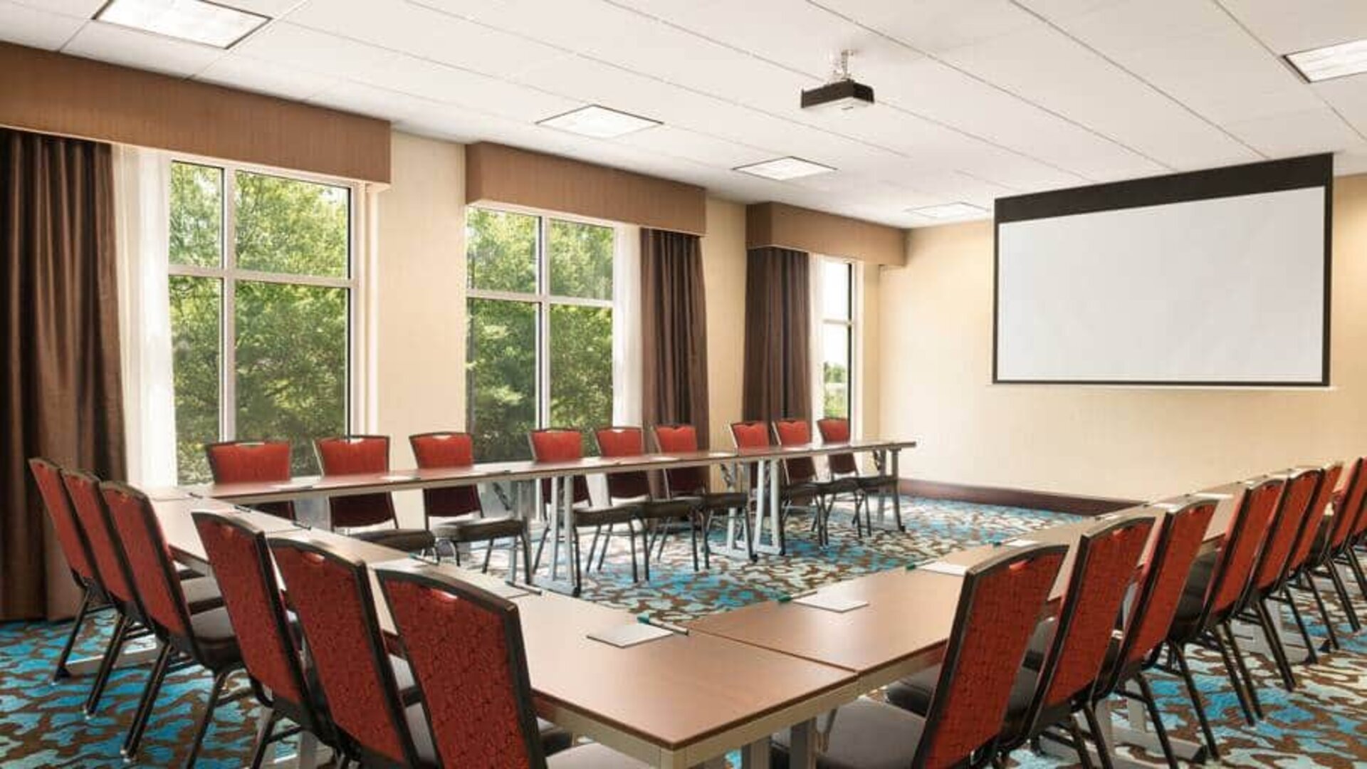 Meeting room with projector board for board meetings at the Homewood Suite by Hilton Atlanta Perimeter.
