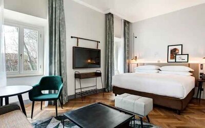 Spacious king bedroom with desk and TV screen at the DoubleTree by Hilton Rome Monti.