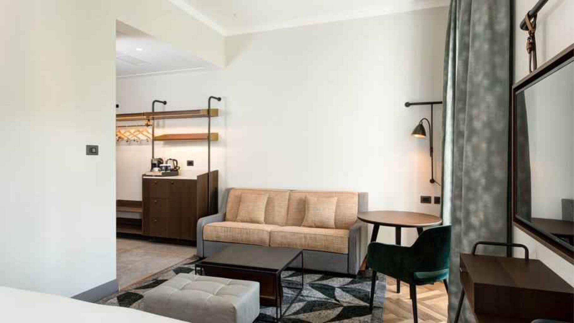 Living room with desk and sofa at the DoubleTree by Hilton Rome Monti.