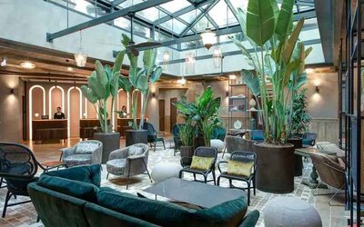 Beautiful lobby workspace with plants at the DoubleTree by Hilton Rome Monti.