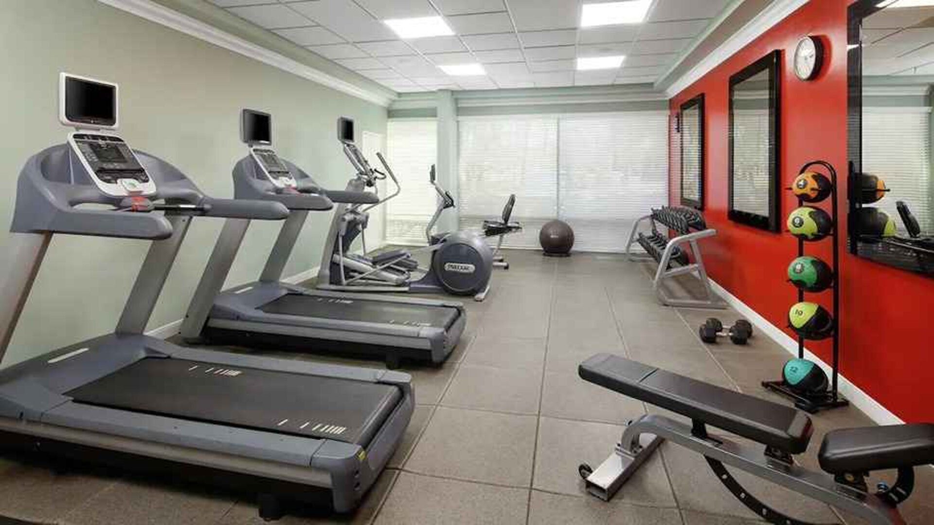fitness center well equipped with treadmills and weights at DoubleTree by Hilton Hotel San Diego - Hotel Circle.