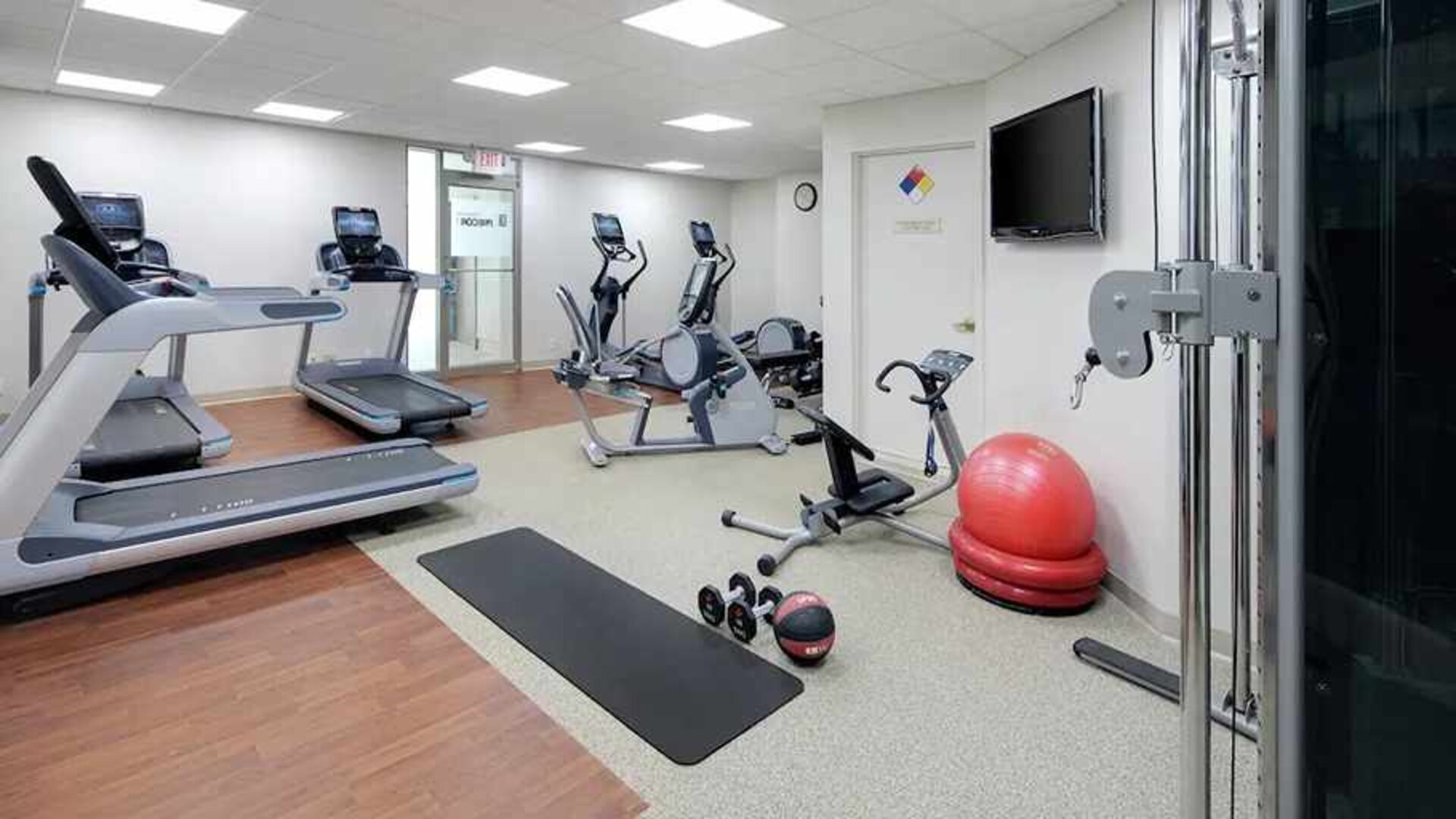fitness center well equipped with treadmills and weights at Embassy Suites by Hilton Detroit Troy Auburn Hills.