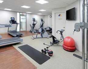 fitness center well equipped with treadmills and weights at Embassy Suites by Hilton Detroit Troy Auburn Hills.