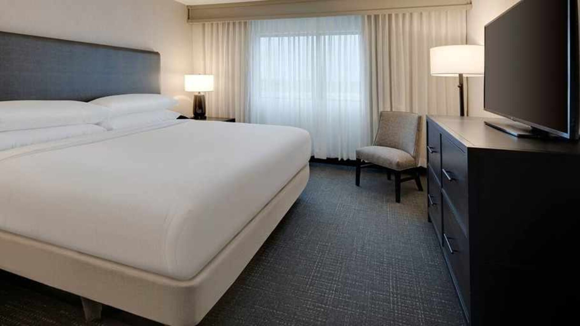 delux king room with TV at Embassy Suites by Hilton Detroit Troy Auburn Hills.