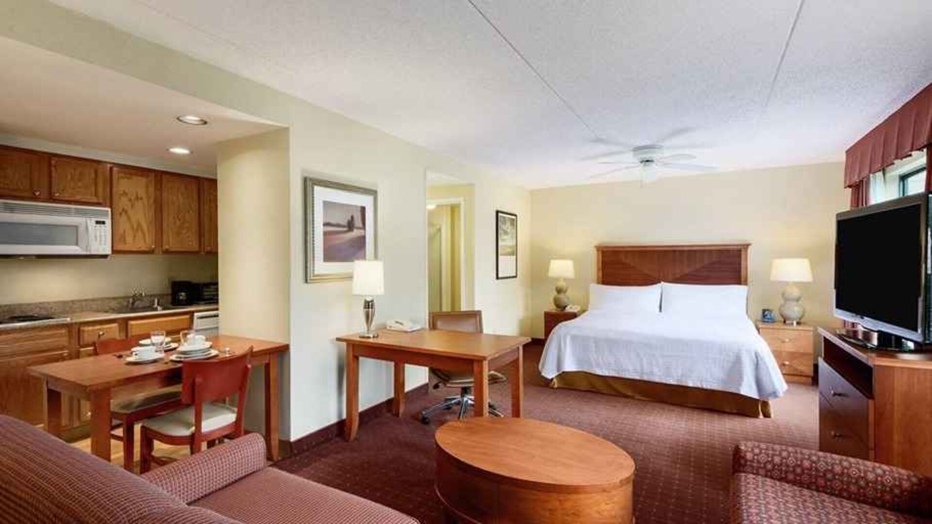 beautiful and spacious king bedroom with work desk, lounge area, and kitchenette at Homewood Suites by Hilton Newark-Wilmington South Area.