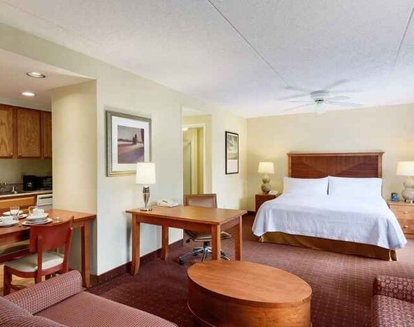 beautiful and spacious king bedroom with work desk, lounge area, and kitchenette at Homewood Suites by Hilton Newark-Wilmington South Area.
