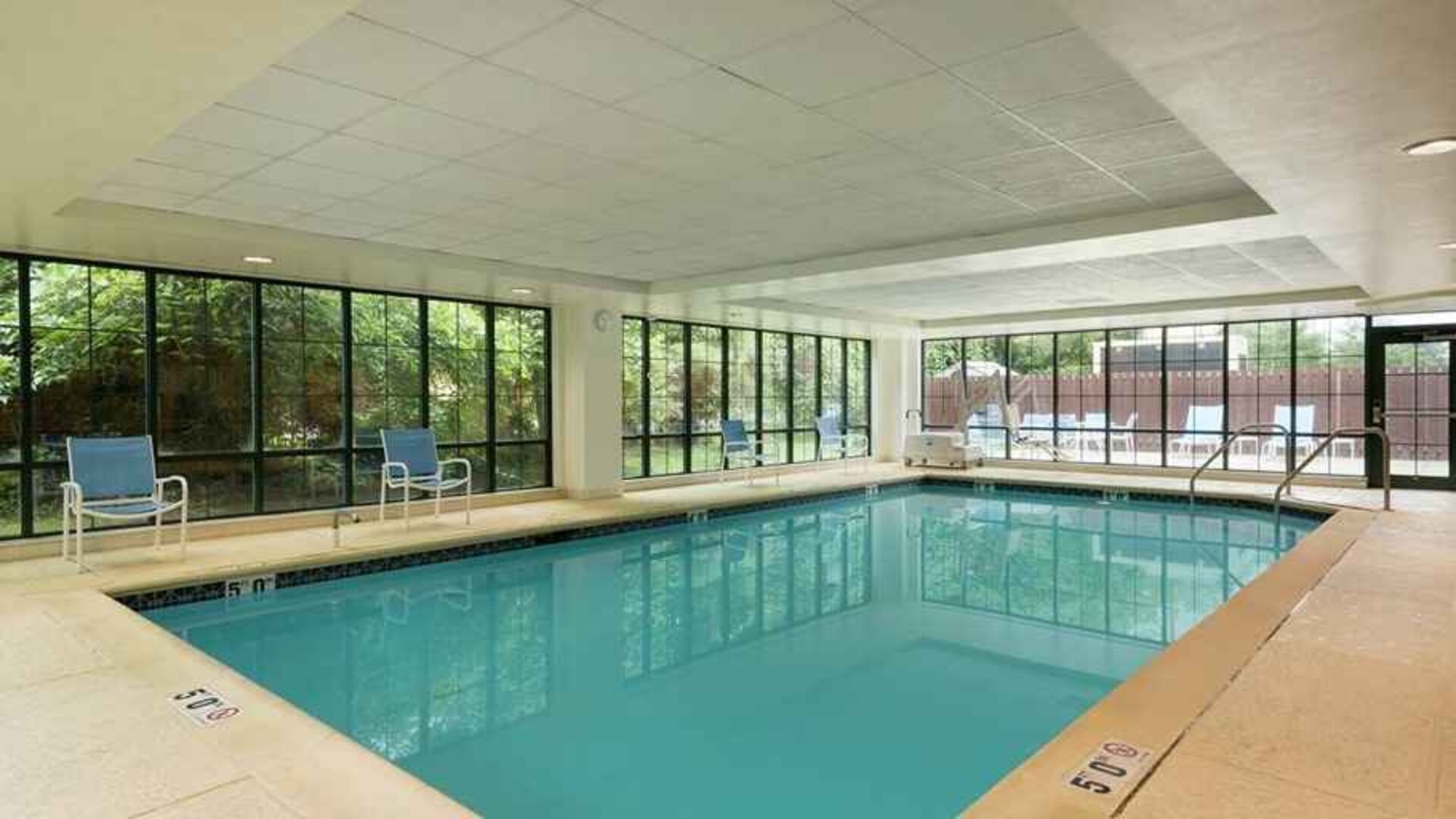 lovely indoor pool with seating area at Homewood Suites by Hilton Newark-Wilmington South Area.