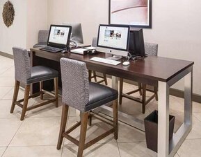 Business center and coworking space equipped with work desk, PC, internet, and printers at DoubleTree by Hilton Hotel Wilmington.