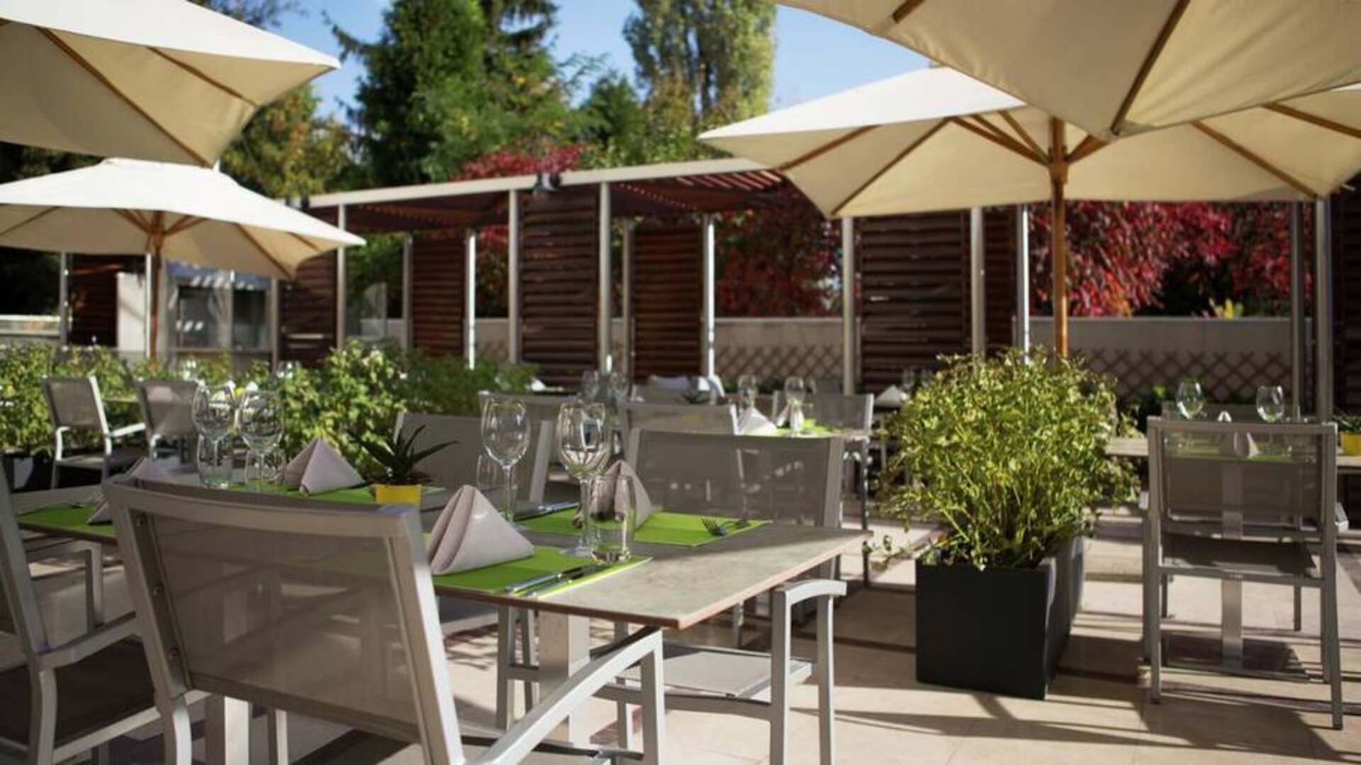 Outside area with seating and table umbrellas, perfect for dining, socializing, working.