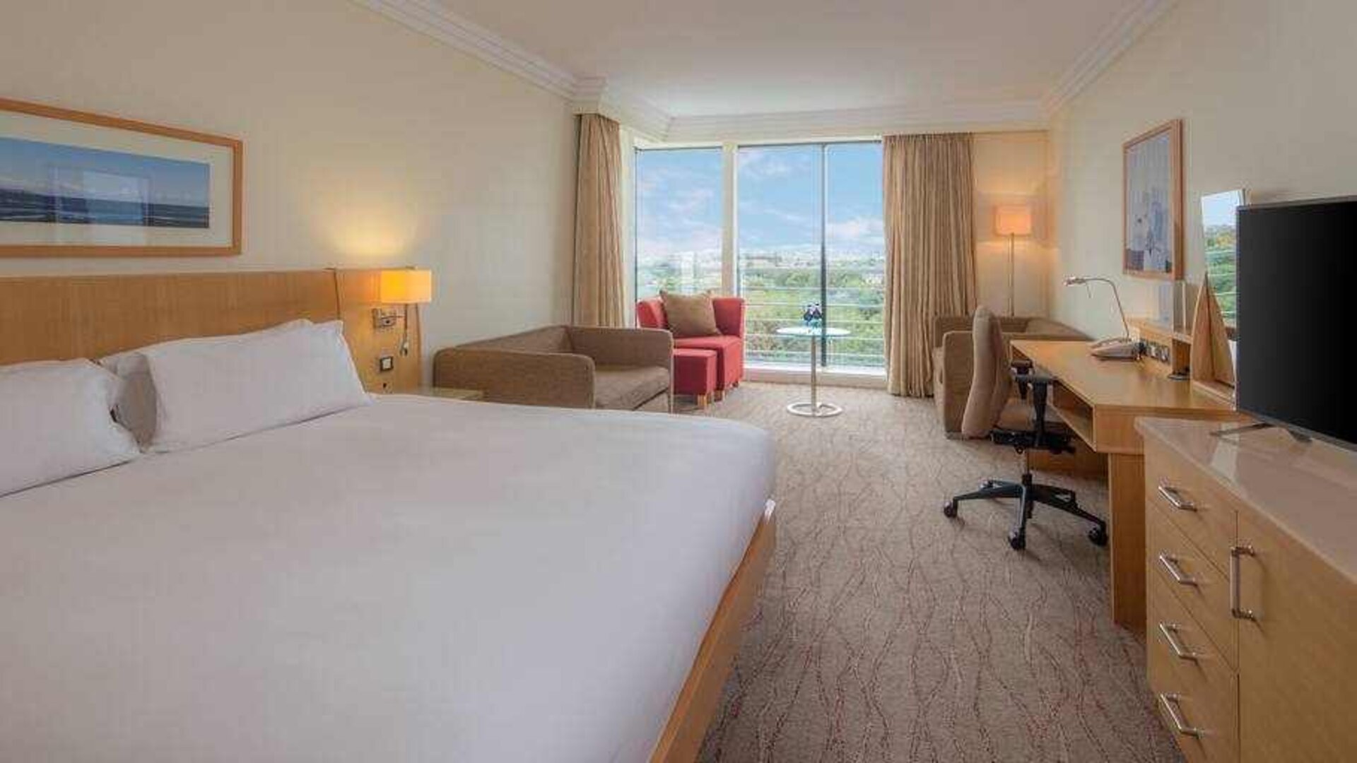 Large king suite with working station at the Hilton Dublin Airport.
