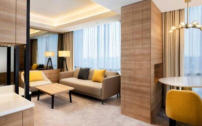 Spacious living room with working station in a king suite at the Hilton Garden Inn Jakarta Taman Palem.
