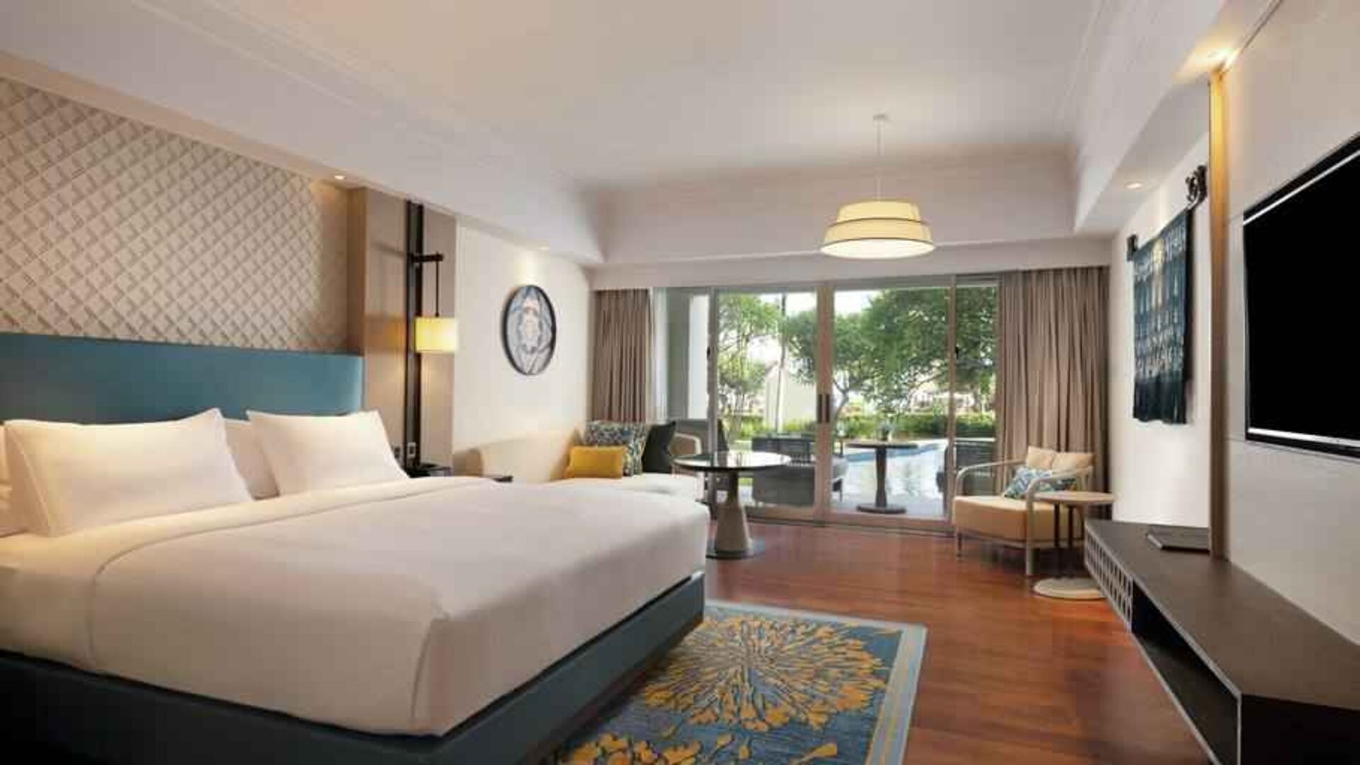 Spacious king bedroom with desk at the Hilton Bali Resort.