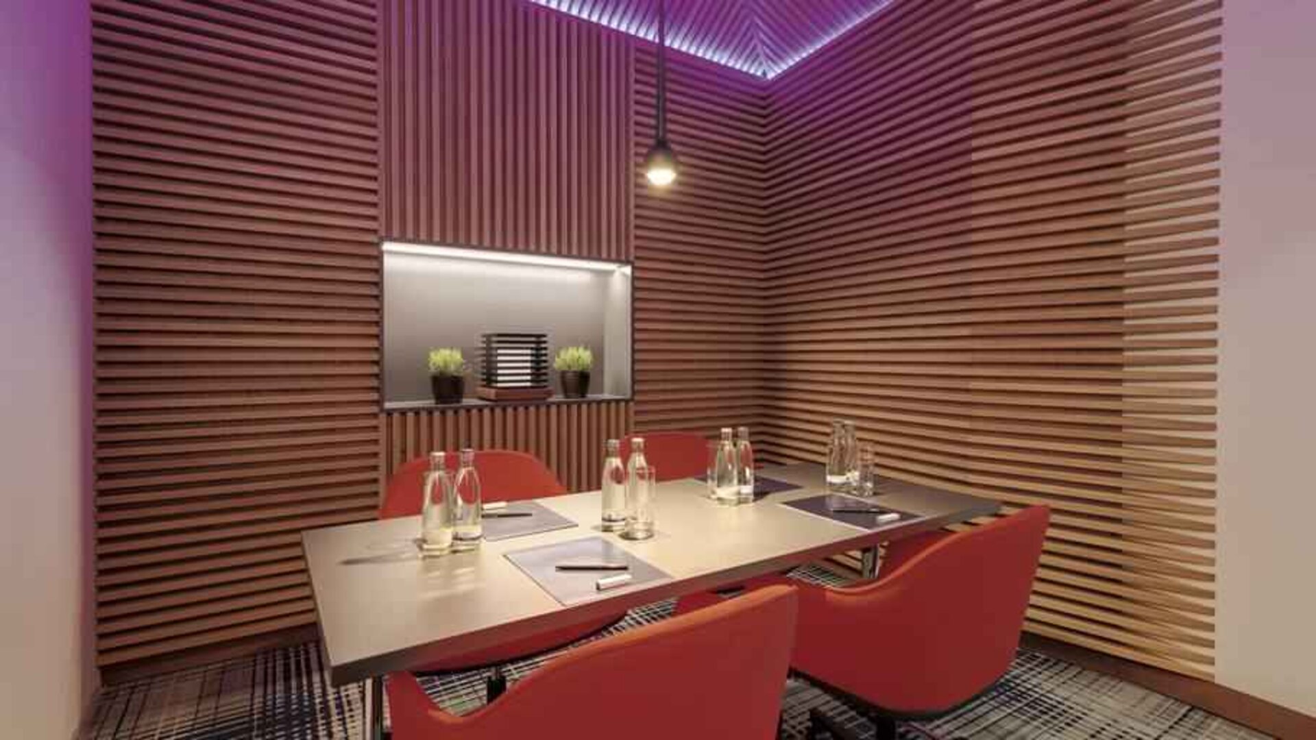 Small meeting room with square table at the Hilton Munich Airport.