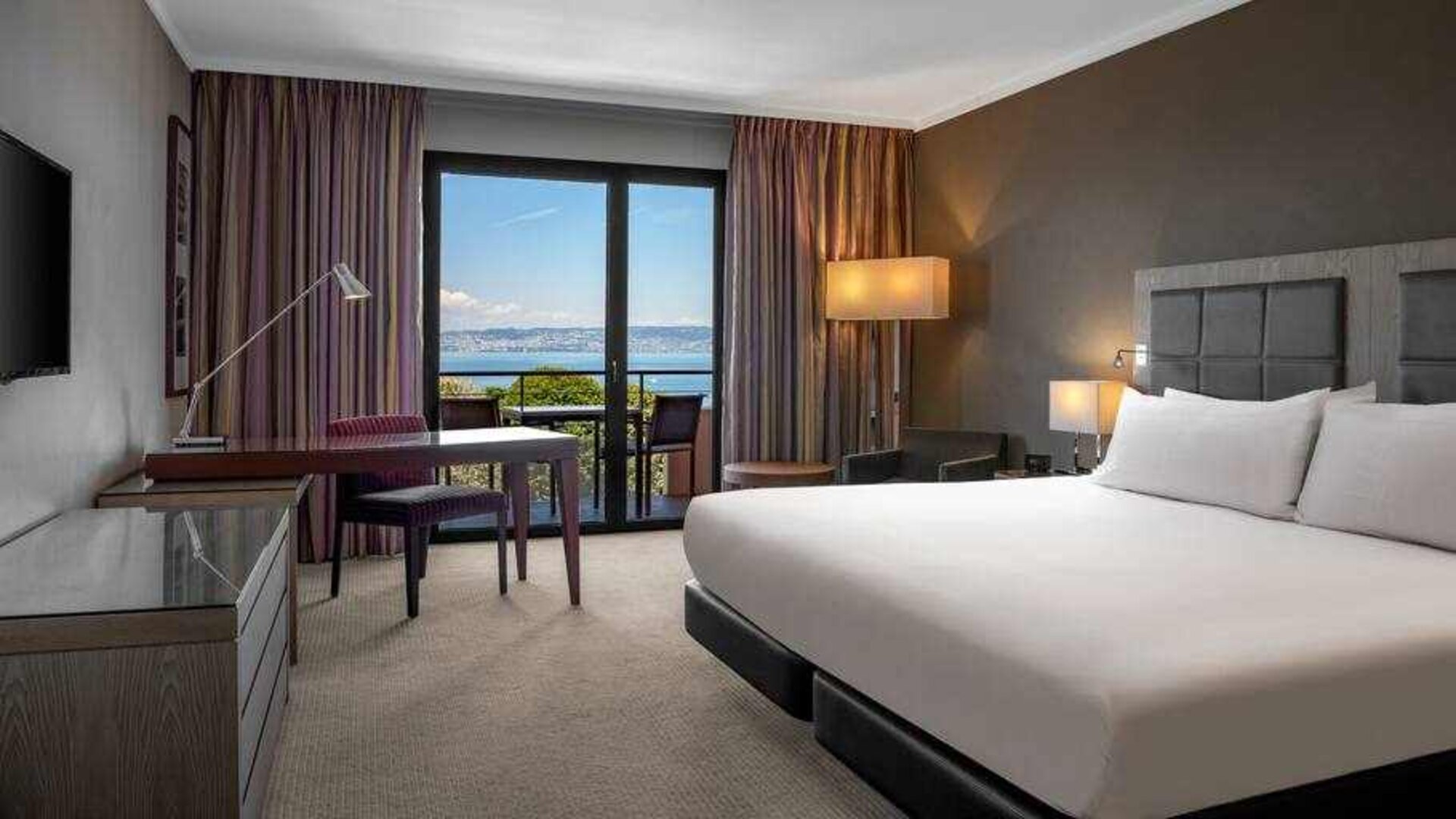 King bedroom with lake view at the Hilton Evian-les-Bains.