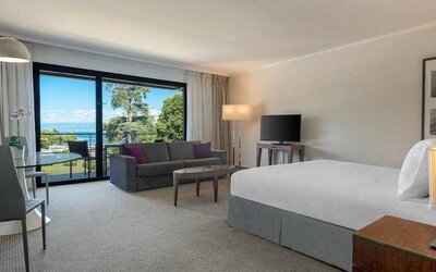 Hotel studio with sofa, TV screen and desk at the Hilton Evian-les-Bains.