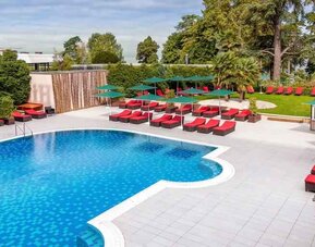Outdoor pool with lounges at the Hilton Evian-les-Bains.