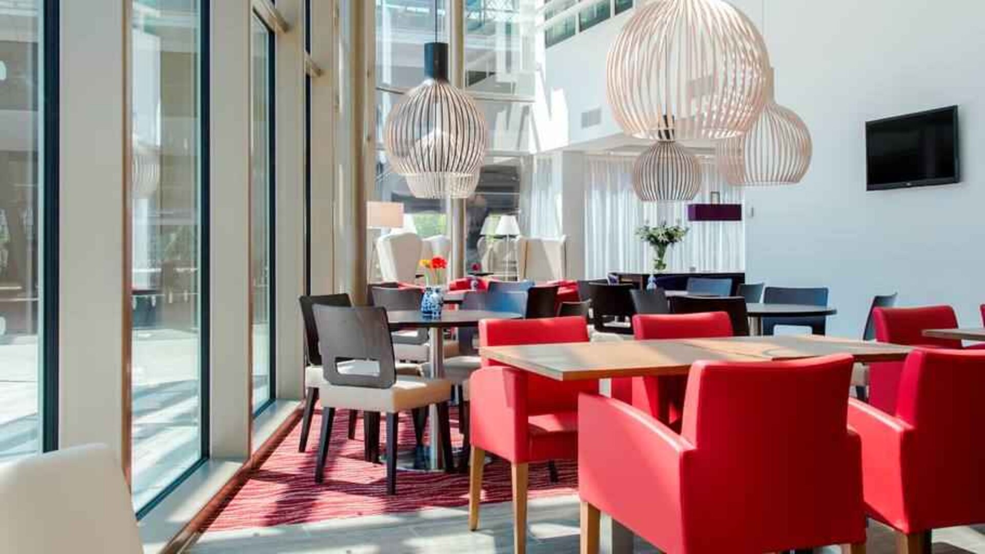 Hotel workspace with chairs and tables at the Hampton by Hilton Amsterdam Arena Boulevard.