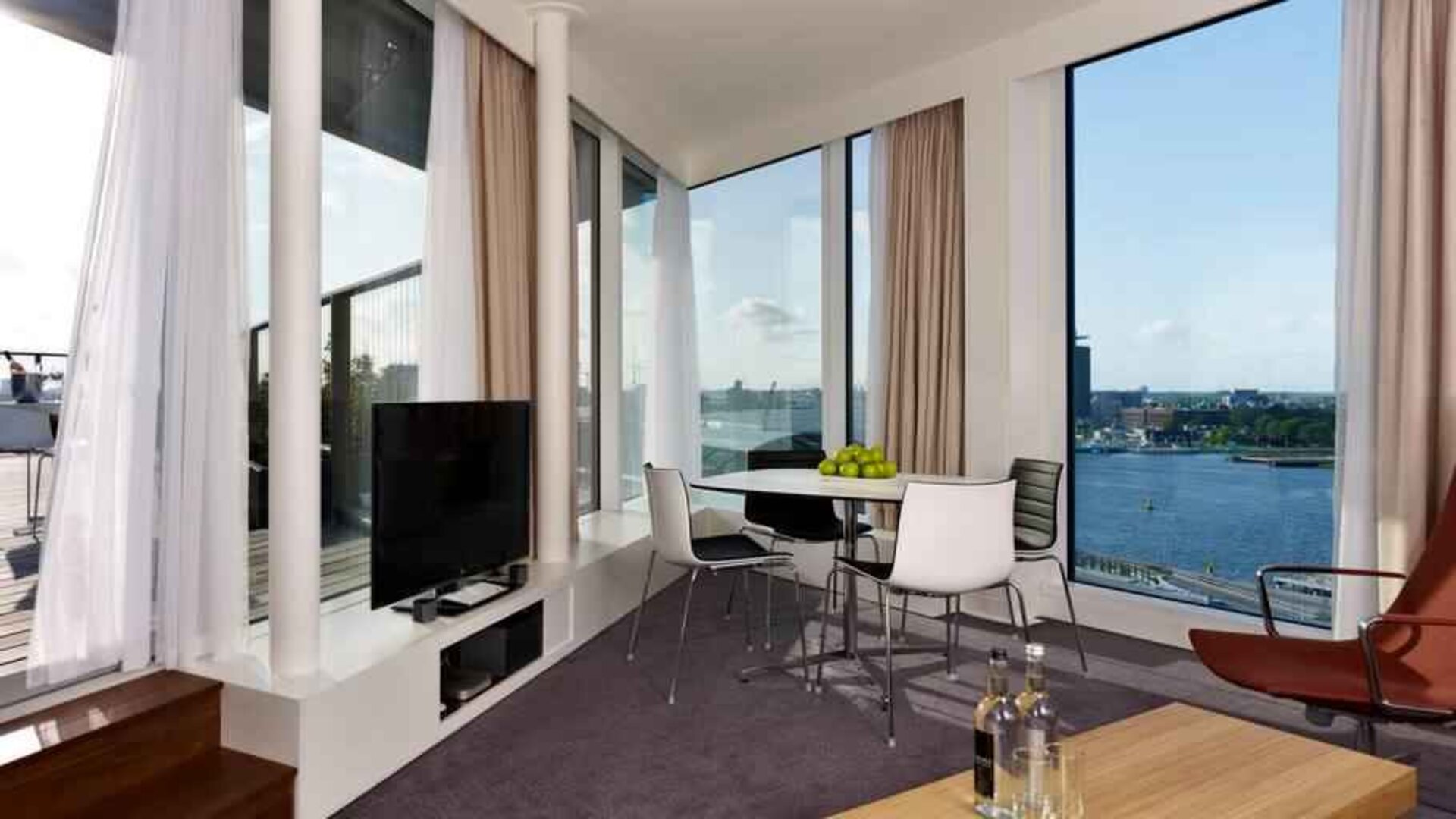 Bright living room overlooking the canals at the DoubleTree by Hilton Amsterdam Centraal Station.
