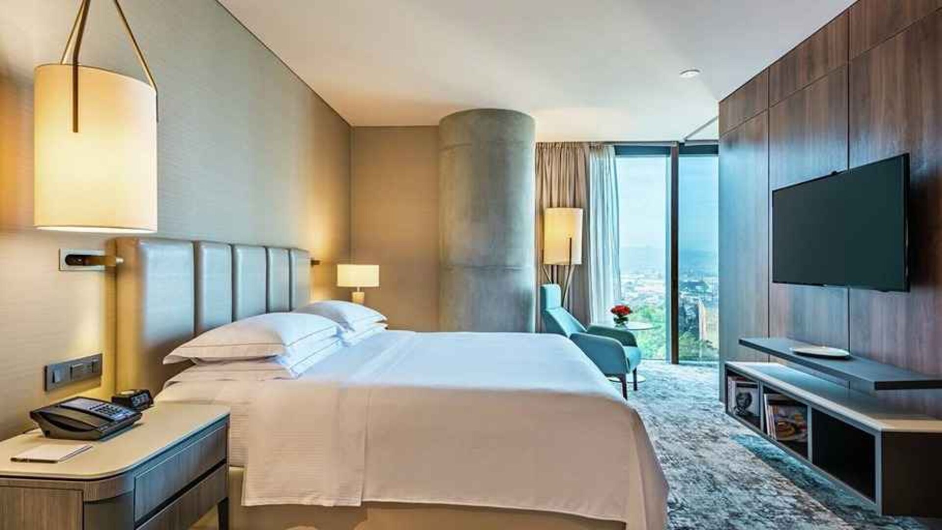 spacious king room with TV and lots of natural light at Hilton Bogota Corferias.