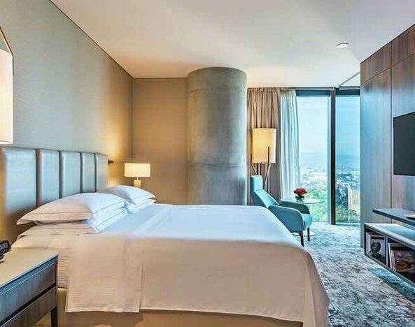 spacious king room with TV and lots of natural light at Hilton Bogota Corferias.