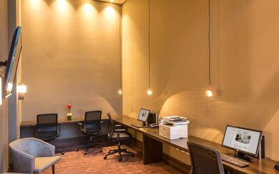 dedicated business center with PC, internet, work desks, and printer at Hilton Garden Inn Bogota Airport.