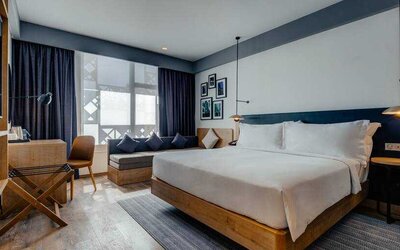 King guestroom with sofa and desk at the Hilton Garden inn Casablanca Sud.