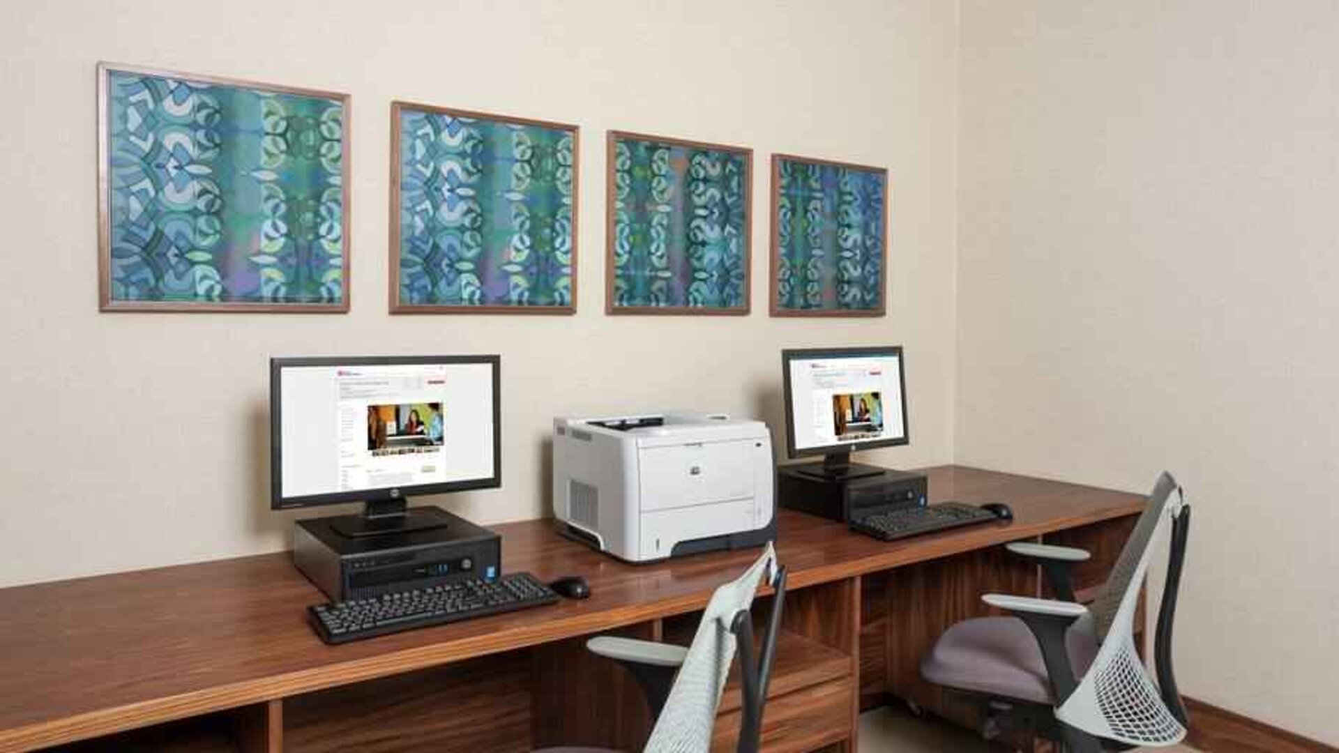 Business center with computers and printer at the Hilton Garden Inn Tanger City Center.