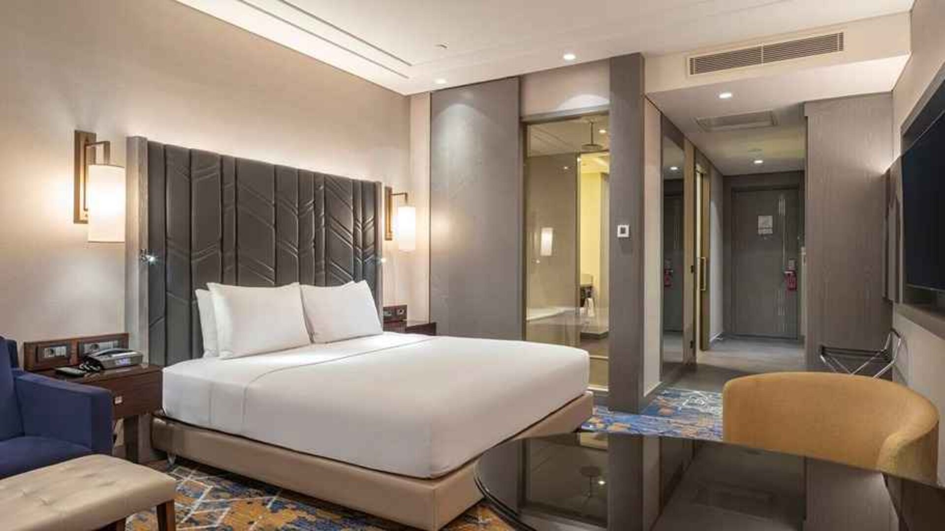 spacious king suite with TV, desk, and lounge area at Hilton Istanbul Bakirkoy.