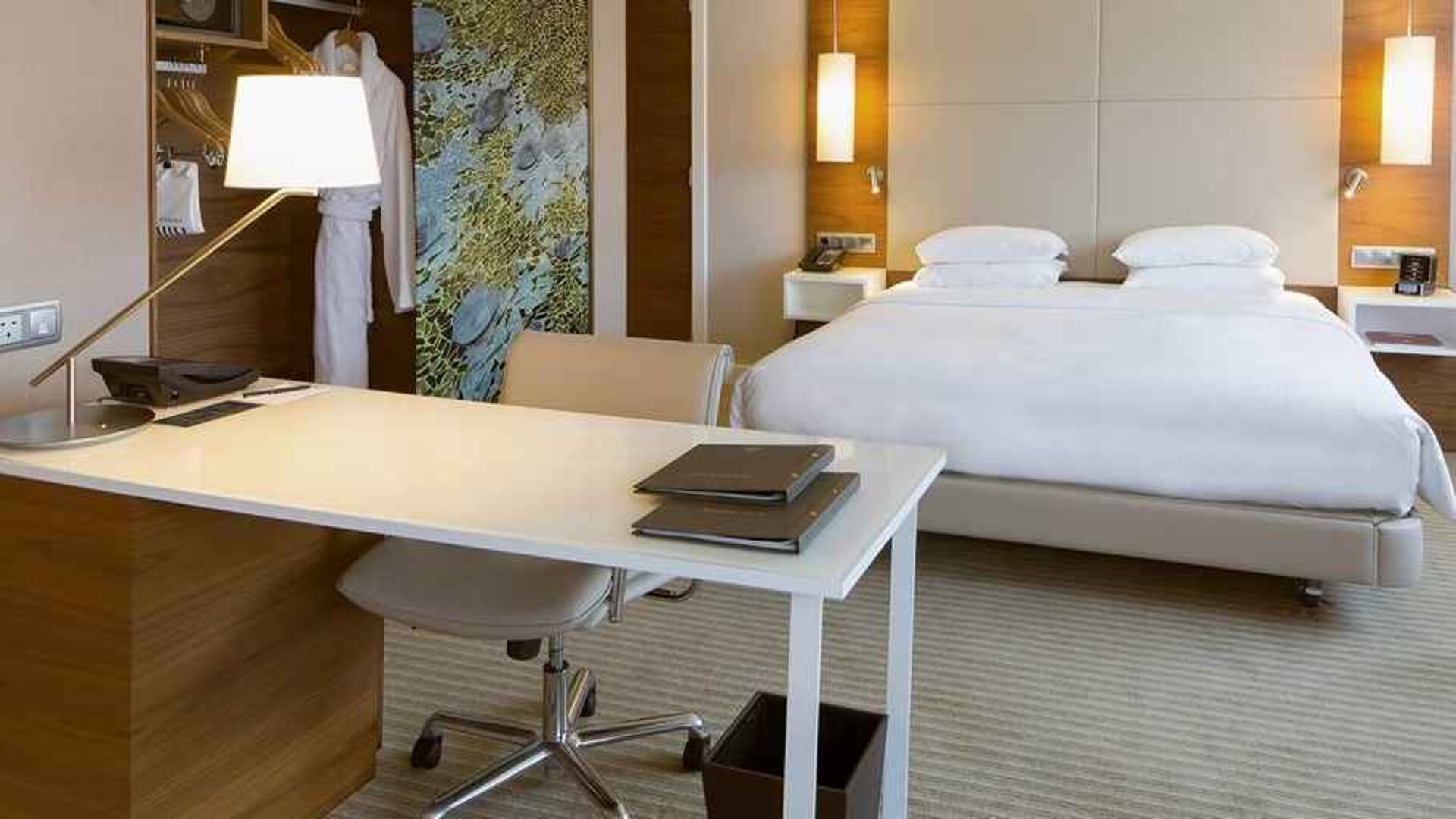luxurious king suite with business desk ideal for working remotely at Hilton Barcelona.