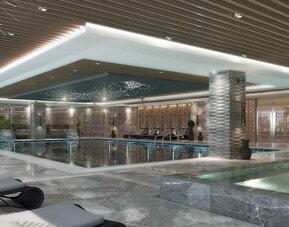 luxurious indoor pool surrounded by sunbeds at DoubleTree by Hilton Manisa.