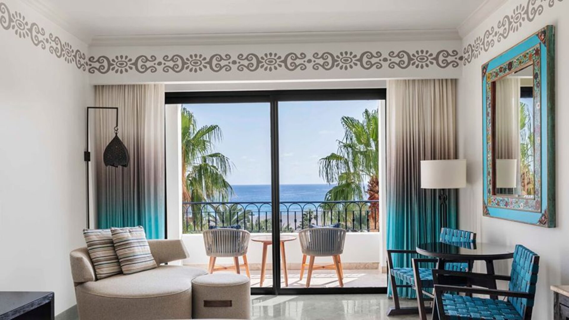 Living room with balcony perfect as workspace at the Hilton Los Cabos Beach & Golf Resort.