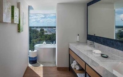Bathroom with bath tub overlooking the airport at the Hilton Garden Inn Cancun Airport.