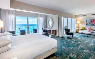 King suite with working station overlooking the sea at the Caribe Hilton.