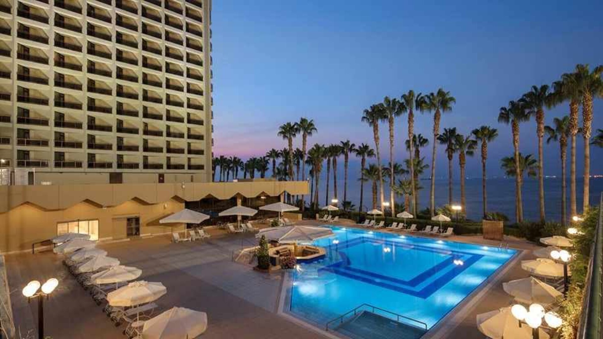 stunning outdoor pool with sun beds and seating area at Mersin HiltonSA.