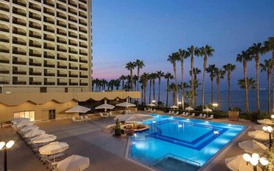 stunning outdoor pool with sun beds and seating area at Mersin HiltonSA.