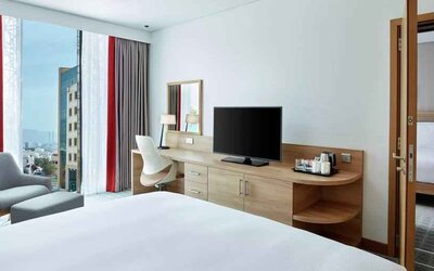 King suite with working station along the window at the Hilton Garden Inn Muscat Al Khuwair.