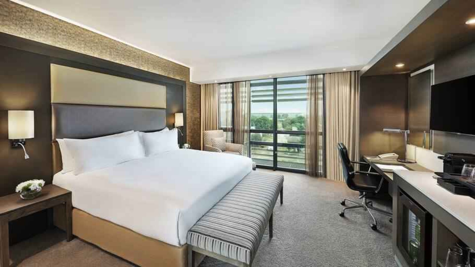 King bedroom with desk at the Legend Hotel Lagos Airport, Curio Collection by Hilton.
