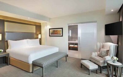 Elegant king suite with TV screen at the Legend Hotel Lagos Airport, Curio Collection by Hilton.