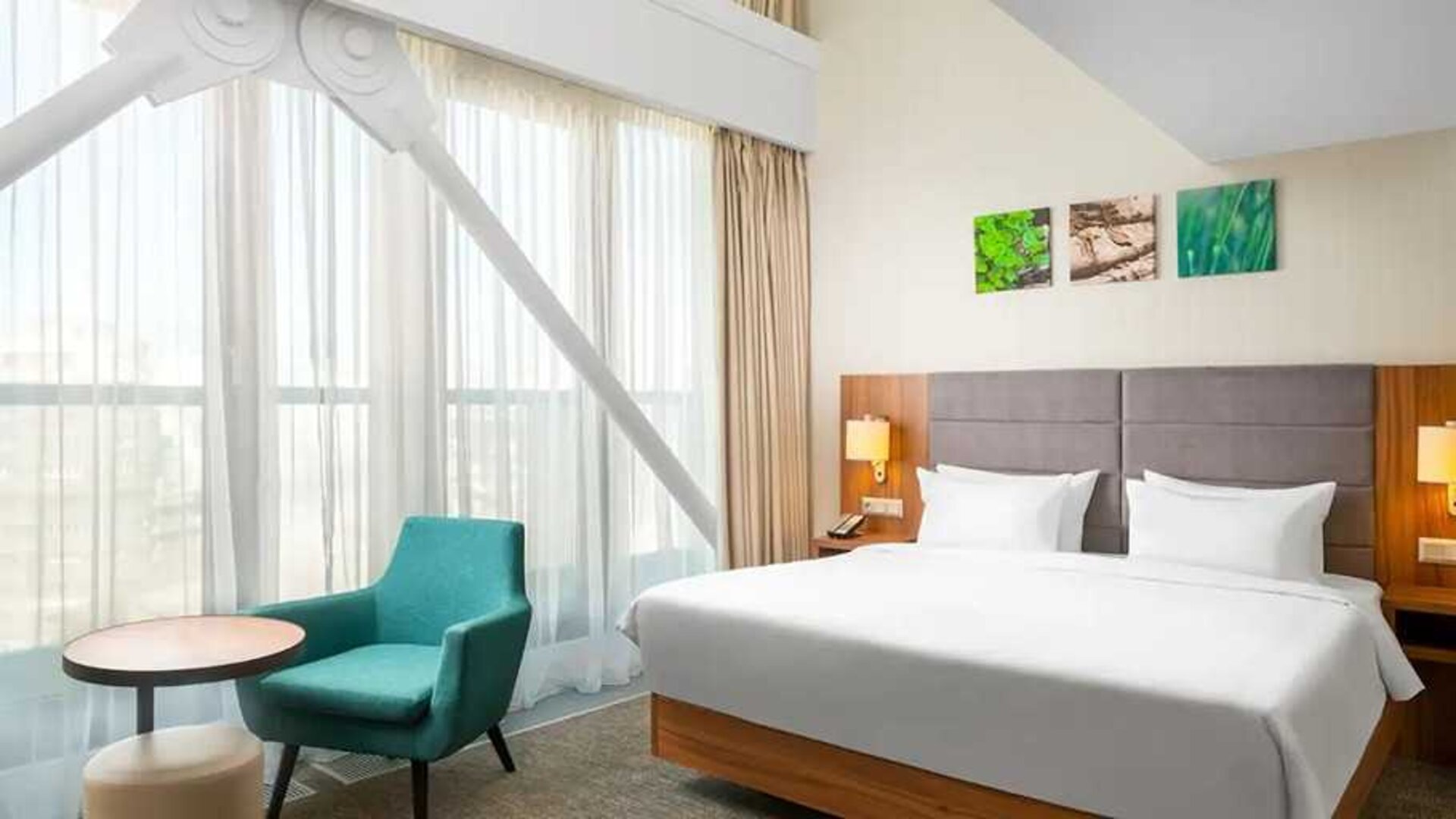 comfortable king room with couch at Hilton Garden Inn Bucharest Old Town.