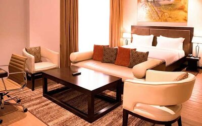 luxurious king suite with lounge area, business desk, and chair at DoubleTree by Hilton Nairobi Hurlingham.