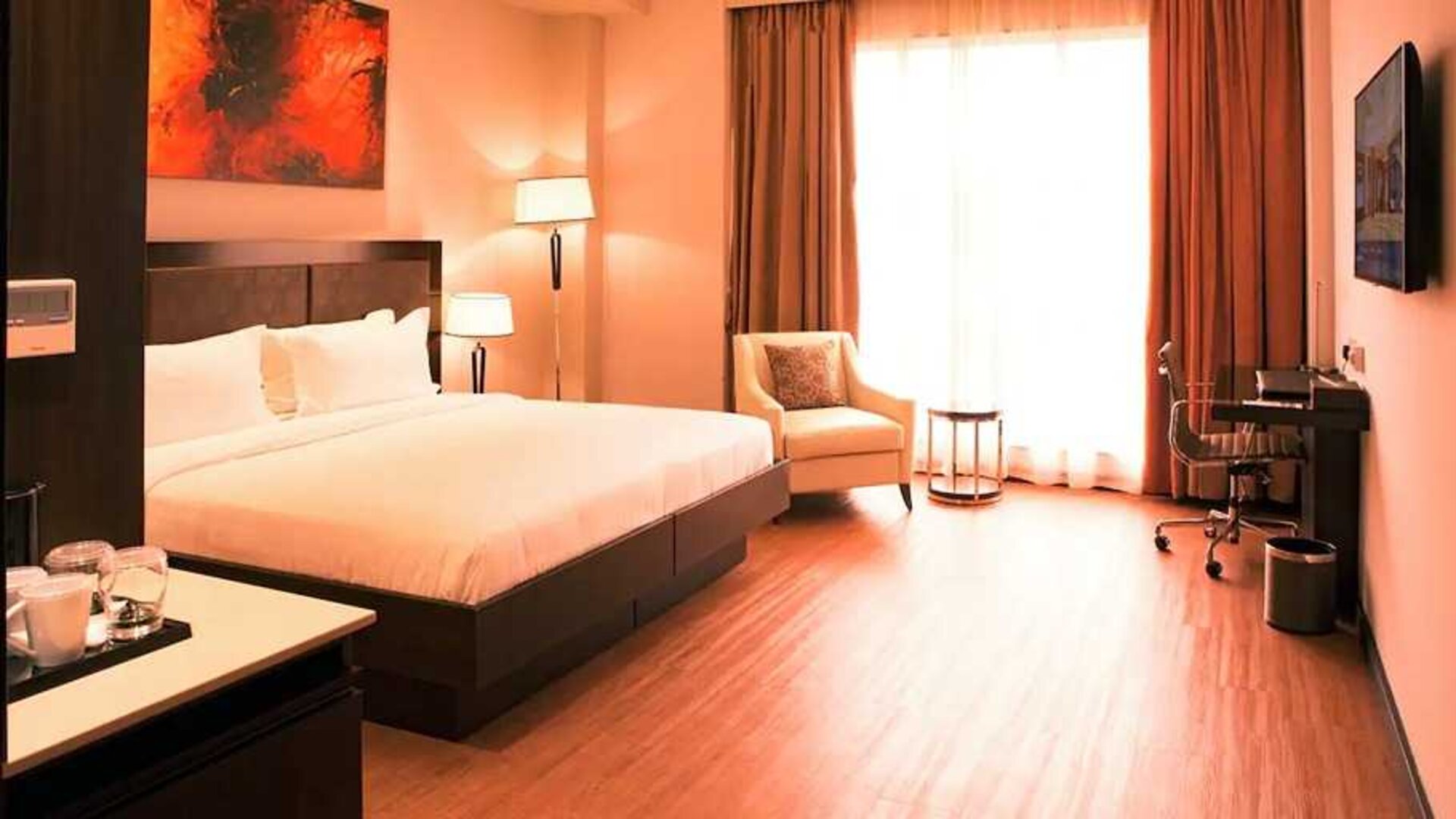 spacious king room with business desk, chair, TV, and couch at DoubleTree by Hilton Nairobi Hurlingham.