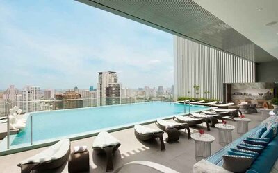 Beautiful outdoor pool with lounges overlooking the city at the Hilton Sukhumvit Bangkok.